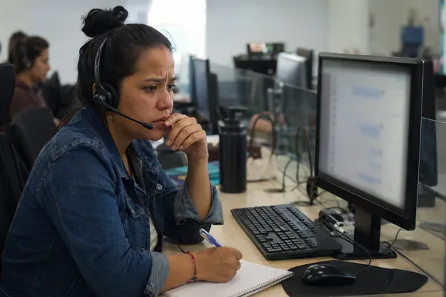 Agent handles a demanding call while monitoring a chat channel.