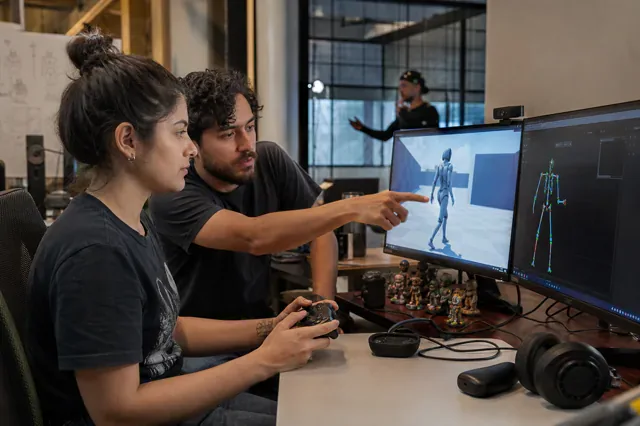 Designer and animator test a character's movement with a controller.